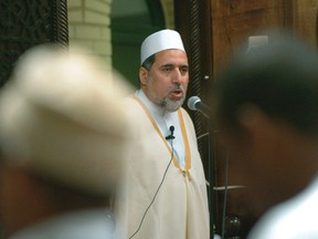 In this June 15, 2005 file photo, Imam Shaker Elsayed delivers the sermon at prayers services at the Dar al-Hijra mosque in Falls Church, Va. Imam Johari Abdul-Malik, who was director of outreach at the Dar Al-Hijrah mosque in Falls Church, posted his resignation Friday on his website. (AP Photo/Kevin Wolf)