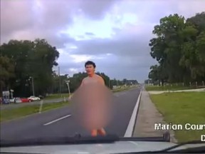 Police allege Andrew Humphries, 18, was picked up by an officer while walking naked down the side of a Florida road in this screenshot of dashcam footage released by Marion County Sheriff's Office (Facebook/Marion County Sheriff's Office)