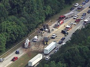 In this image made from video by WSB-TV Atlanta, authorities render assistance to injured people on an overturned church bus, Thursday, June 8, 2017, in Atlanta. Mount Zion Baptist Church in Huntsville, Ala., posted on its Facebook page that one of its buses with its student ministry mission was involved in a crash while traveling to the airport. (WSB-TV via AP)