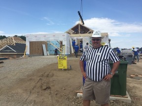 Doug Tarry stands beside the Project Hope site in St. Thomas on Friday afternoon. The house is being built through the help of volunteers over the weekend. (Laura Broadley/Times-Journal)