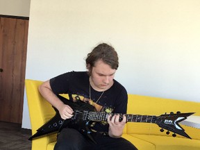 In this June 8, 2017 photo, Johnny Crow, 16, strums his guitar in Port Huron, Mich. (Liz Shepard/The Times Herald via AP)