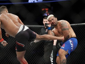 Alistair Overeem kicks Mark Hunt during a heavyweight bout at UFC 209 on March 4, 2017. (AP Photo/John Locher)
