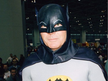 In this Jan. 27, 1989 file photo, Adam West dresses as his character Batman and Robin respectively during an appearance at the "World of Wheels" custom car show in Chicago. West died Friday, June 9, 2017, at the age of 88.  (AP Photo/Mark Elias, File)