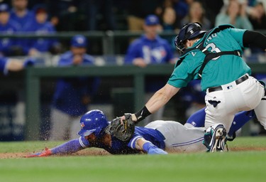 Toronto Blue Jays' Kevin Pillar is tagged out at home by Seattle Mariners catcher Mike Zunino during the seventh inning of a baseball game, Friday, June 9, 2017, in Seattle. (AP Photo/John Froschauer)