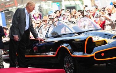Adam West, who played Batman in the original TV series, touches the Batmobile as a crowd gathers to watch as West receives his star on Hollywood's Walk of Fame on April 5, 2012 in Hollywood, Calif. (FREDERIC J. BROWN/AFP/Getty Images)