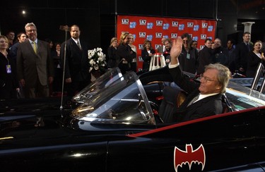 Adam West waves as he arrives in his original Batmobile to the TV Land and Nick at Nite Upfront in "The Bat Cave" on Broadway in New York City on April 24, 2002.  (Gabe Palacio/Getty Images)