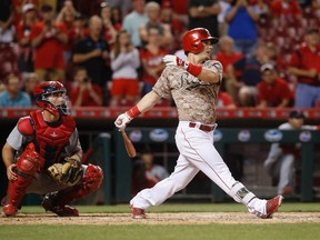 Cinci's Scooter Gennett launches his fourth homer of the night against the Cardinals on Tuesday. (John Minchillo, AP)