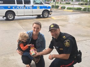 Patrol Sgt. Phil Penner accepts a food donation at the Cram the Cruiser event on Saturday, June 10, 2017, at the Real Canadian Superstore at 3193 Portage Ave. Cram the Cruiser will see donations brought to the cruiser, and then delivered to Winnipeg Harvest at the end of day for people struggling to feed themselves and their families. HANDOUT/Winnipeg Police Service/Twitter