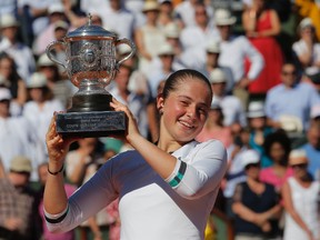 Latvia's Jelena Ostapenko holds the cup after defeating Romania's Simona Halep in the French Open women's final at Roland Garros stadium in Paris on Saturday, June 10, 2017. (Michel Euler/AP Photo)
