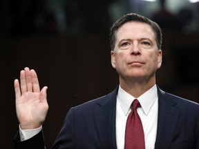 Former FBI Director James Comey is sworn in during a Senate Intelligence Committee hearing on Capitol Hill, Thursday, June 8, 2017, in Washington. (AP Photo/Alex Brandon)