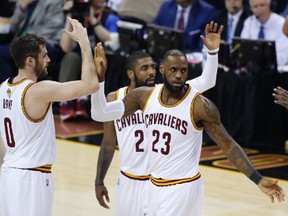 Cavaliers forward LeBron James (23) celebrates with Kevin Love (0) and Kyrie Irving (2) during the first half against the Warriors in Game 4 of the NBA Finals in Cleveland on Friday, June 9, 2017. (Ron Schwane/AP Photo)