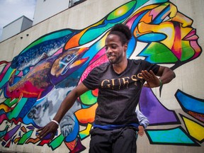 Mozaik, the Vanier street party, shut down part of Montreal Road on Saturday for the unveiling of Ottawa's tallest mural. Duanse Bellot known as Deec1ple shows off his moves in front of the giant mural.