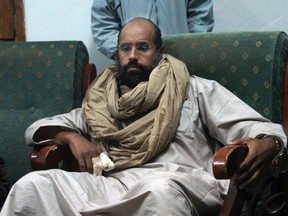 In this Nov. 19, 2011, file photo, Seif al-Islam is seen after his capture in the custody of revolutionary fighters in Zintan, a town south of the capital Tripoli, Libya. A statement by his captors, the Abu Bakr al-Siddiq Battalion, said Seif al-Islam was released on Friday, June 9, 2017, but gave no details on his whereabouts. They declined to disclose his whereabouts, citing concerns over his safety. (AP Photo/Ammar El-Darwish, File)