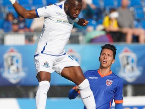 FC Edmonton's Sainey Nyassi (14) heads the ball as Miami FC's Roberto Baggio Kcira (14) defends during first half action at Clarke Park on Saturday. (Jason Franson)