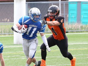 Jared Loyer, left, of the Sudbury varsity Gladiators, attempts to elude Emerson DeCarlo, of the Peterborough Wolverines, during football action at James Jerome Sports Complex in Sudbury, Ont. on Saturday June 10, 2017. John Lappa/Sudbury Star/Postmedia Network