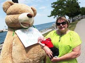 Shirley Roebuck with the Sarnia-Lambton Health Coalition poses with two-week-old Hunter French in front of a seven-foot stuffed bear at the Point Edward waterfront Saturday. Roebuck was lending her voice in an Ontario Health Coalition awareness campaign about private clinics illegally billing for medical care covered under Canada's universal program. French's mom Sara is a friend of Roebuck. Tyler Kula/Sarnia Observer/Postmedia Network