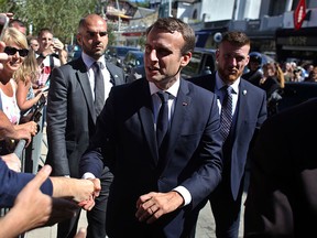 France's President Emmanuel Macron meets people as he arrives at his house in Le Touquet, eastern France, Saturday, June 10, 2017. (AP Photo/Thibault Camus)