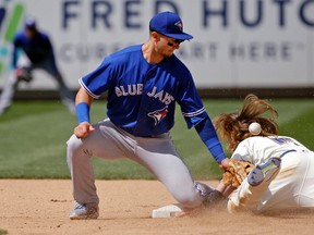 The ball bounces from the glove of Toronto Blue Jays shortstop Troy Tulowitzki and onto the back of Seattle Mariners’ Ben Gamel Sunday, June 11, 2017, in Seattle. (AP Photo/Elaine Thompson)