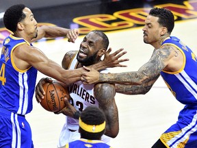 LeBron James of the Cleveland Cavaliers drives to the basket against Shaun Livingston and Matt Barnes of the Golden State Warriors during Game 4 of the NBA Finals at Quicken Loans Arena on June 9, 2017 in Cleveland. (Jason Miller/Getty Images)