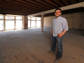 Marvin Rivas stands on his property above what used to be The Honest Lawyer bar on Dundas Street, just east of Clarence in London, Ont. Rivas intends to turn three floors into affordable housing. (MIKE HENSEN, The London Free Press)