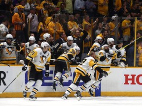 Patric Hornqvist (right, 72) and his Penguins teammates stream off the bench after time runs out in Game 6 on Sunday, clinching the team's second Stanley Cup title in a row.