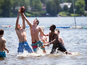 A group of young men were enjoying a game of football in the water at Mooney's Bay beach.