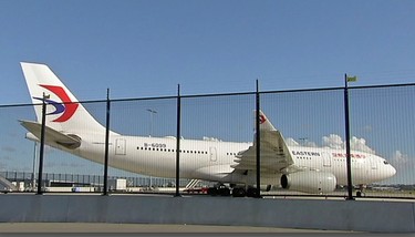 In this image made from video, China Eastern airlines Flight 736 is parked on the tarmac after it landed in Sydney, Australia, Monday, June 12, 2017. China Eastern said the crew on Flight 736 noticed damage to the air inlet on the left engine after takeoff Sunday evening and the captain decided to return. (Australian Broadcasting Corporation via AP)