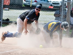 Matt McGill (left), catcher with the Mitchell Mets, blocks the plate but the ball eludes him during action last Sunday from the ‘B’ semi-final of the Mitchell Mets tournament against the Walton Brewers. The Mets lost 5-3. ANDY BADER/MITCHELL ADVOCATE