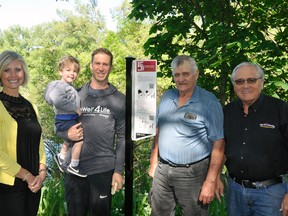 Standing adjacent to sign #5 along the West Perth Thames Nature Trail in Mitchell include Melissa Snyders (left), representing husband Shawn and his business Snyders Graphics of Bornholm; AJ Moses holding 1 ½ year-old son Jeter, of Live Well 4 Life Inc.; Bert Vorstenbosch, Sr. and Gerry Kehl, both of the West Perth Energy & Environment Committee. ANDY BADER/MITCHELL ADVOCATE