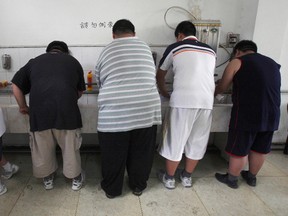 In this Thursday, July 24, 2008 file photo, obese patients wash their plates after lunch at the Aimin Fat Reduction Hospital in Tianjin, China. The hospital uses a combination of diet, exercise and traditional Chinese acupuncture to treat rising obesity rates. Research released Monday, June 12, 2017 found the obesity epidemic is getting worse in most parts of the world, according to data between 1980 and 2015. (AP Photo/Ng Han Guan)