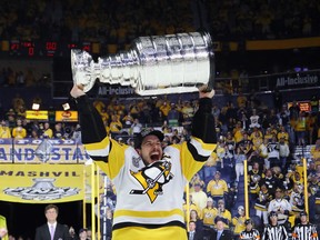 Sidney Crosby #87 of the Pittsburgh Penguins celebrates with the Stanley Cup Trophy after they defeated the Nashville Predators 2-0 to win the 2017 NHL Stanley Cup Final at the Bridgestone Arena on June 11, 2017 in Nashville, Tennessee.