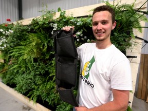 Matt Clarke of RootPro Vertical Gardens shows his hanging planters made from geotextile at his Thorndale business. (MIKE HENSEN, The London Free Press)