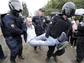 Police detain a protester during an anti-corruption rally in St.Petersburg, Russia, on Monday, June 12, 2017. (AP Photo/Dmitry Lovetsky)