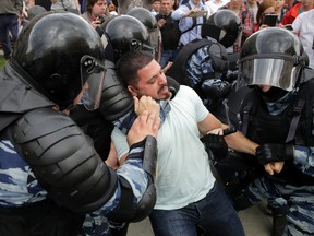Police detain a protester during a demonstration in downtown Moscow, Russia, Monday, June 12, 2017. Russian opposition leader Alexei Navalny, aiming to repeat the nationwide protests that rattled the Kremlin three months ago, has called for a last-minute location change for a Moscow demonstration that could provoke confrontations with police. (AP Photo/Pavel Golovkin)
