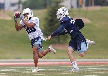 Toronto Argonauts Chandler Worthy WR (80) makes a catch on a rout past Larry Scott DB (35) at their practice facility at York Univeristy  in Toronto, Ont. on Monday June 12, 2017. Jack Boland/Toronto Sun/Postmedia Network