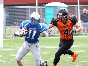 Jared Loyer, left, of the Sudbury varsity Gladiators, attempts to elude Emerson DeCarlo, of the Peterborough Wolverines, during football action at James Jerome Sports Complex in Sudbury, Ont. on Saturday June 10, 2017. John Lappa/Sudbury Star/Postmedia Network
