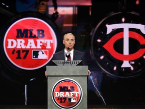 Commissioner Rob Manfred announces the Minnesota Twins select Royce Lewis, a shortstop and outfielder from JSerra Catholic High School in San Juan Capistrano, Calif., with the No. 1 pick in the first round of the Major League Baseball draft, Monday, June 12, 2017, in Secaucus, N.J. (AP Photo/Julio Cortez)