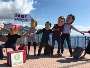 Oxfam activists wearing masks of the leaders of the G7 summit stage a demonstration in Giardini Naxos, near the venue of the G7 summit in the Sicilian town of Taormina, southern Italy, Friday, May 26, 2017. (AP Photo/Paolo Santalucia)