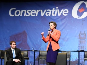 Conservative leadership candidate Kellie Leitch speaks as Andrew Scheer listens during the Conservative Party of Canada leadership debate in Toronto on Wednesday April 26, 2017. THE CANADIAN PRESS/Nathan Denette