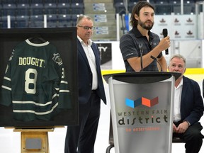 NHL star Drew Doughty watches as his retired number eight for the London Junior Kngihts is raised to the rafters at the Western Fair District Sports Centre on Monday June 12, 2017. At left is Knights VP of hockey operations Kevin Gardner and at right Kevin Egan, president of the Junior Knights (Morris Lamont/The London Free Press)