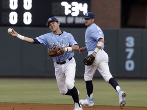 North Carolina shortstop Logan Warmoth (7) throws out a Davidson runner during the first inning of an NCAA college baseball tournament regional game in Chapel Hill, N.C., Sunday, June 4, 2017. (AP Photo/Gerry Broome)