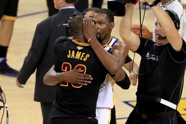 OAKLAND, CA - JUNE 12:  Kevin Durant #35 of the Golden State Warriors hugs LeBron James #23 of the Cleveland Cavaliers after defeating the Cleveland Cavaliers 129-120 in Game 5 to win the 2017 NBA Finals at ORACLE Arena on June 12, 2017 in Oakland, California. NOTE TO USER: User expressly acknowledges and agrees that, by downloading and or using this photograph, User is consenting to the terms and conditions of the Getty Images License Agreement.  (Photo by Ronald Martinez/Getty Images)