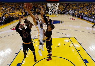 Golden State Warriors' Stephen Curry, center, drives between Cleveland Cavaliers' LeBron James, left, and Kyle Korver during the second half in Game 5 of basketball's NBA Finals Monday, June 12, 2017, in Oakland, Calif. (AP Photo/Marcio Jose Sanchez) ORG XMIT: OAS302
