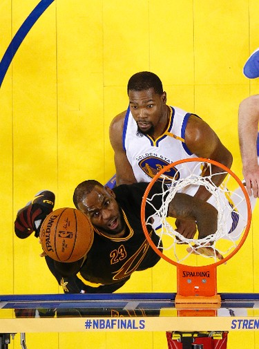 Cleveland Cavaliers forward LeBron James, left, shoots against Golden State Warriors forward Kevin Durant during the second half of Game 5 of basketball's NBA Finals in Oakland, Calif., Monday, June 12, 2017. The Warriors won 129-120 to win the NBA championship. (Monica M. Davey/Pool Photo via AP) ORG XMIT: OAS206