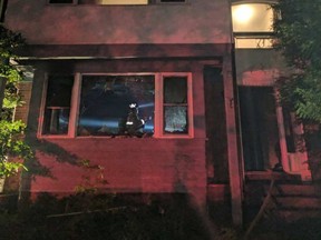 An Ottawa firefighter stands in a smoke-filled living room on Rideau Terrace late Monday night. SCOT STILBORN / OTTAWA FIRE PHOTOS
