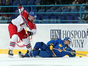 Sweden's Erik Brannstrom (4) gets tangled up with the Czech Republic's Jachym Kondelik (25) during preliminary round action at the 2017 IIHF Ice Hockey U18 World Championship. Steve Kingsman/HHOF-IIHF Images