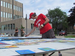 Artist Paul Lavoie, with the Alberta-based project Canada 150 Mosaic, is shown at work outside Sarnia City Hall Tuesday June 13, 2017 assembling tiles painted by city residents. The project is creating connected mosaic murals in communities across the country. (Paul Morden/Sarnia Observer)