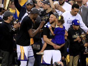 Kevin Durant and Stephen Curry of the Golden State Warriors celebrate after defeating the Cleveland Cavaliers in Game 5 to win the NBA Finals at ORACLE Arena on June 12, 2017. (Ronald Martinez/Getty Images)