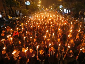 Armenians walk with torches to the monument to the victims of mass killings by Ottoman Turks, in Yerevan, Armenia, Friday, April 24, 2015. Armenians marked the centenary of what historians estimate to be the slaughter of up to 1.5 million Armenians by Ottoman Turks, an event widely viewed by scholars as genocide. Turkey, however, denies the deaths constituted genocide and says the death toll has been inflated. (AP Photo/Sergei Grits)