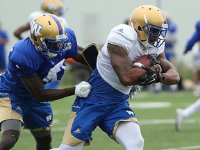 Wide receiver T.J. Thorpe (right) is corralled by defensive back Roc Carmichael during Winnipeg Blue Bombers training camp on the University of Manitoba campus in Winnipeg on Tues., June 13, 2017. Kevin King/Winnipeg Sun